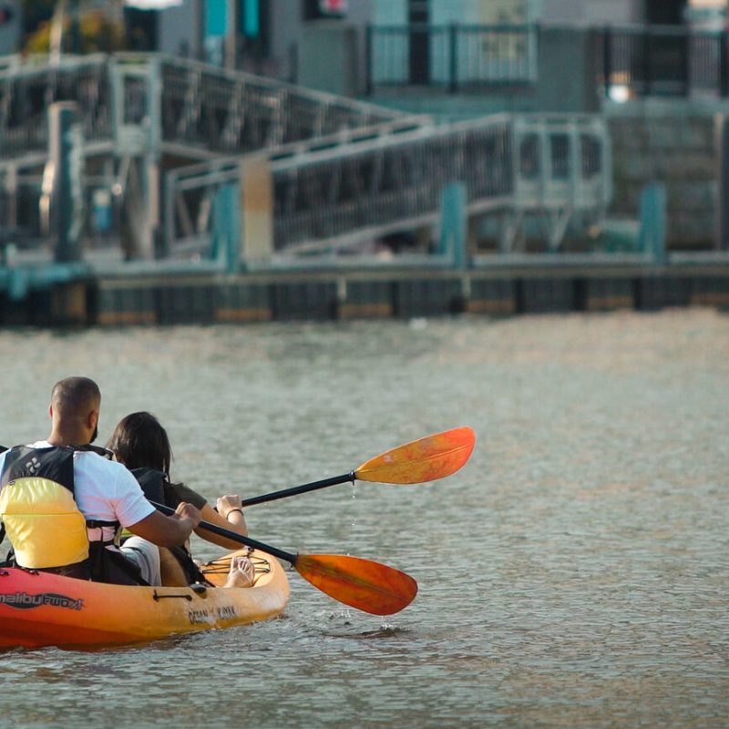Two people paddling on a tandem kayak in Providence, RI