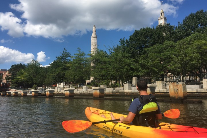 a group of people in a boat on a body of water