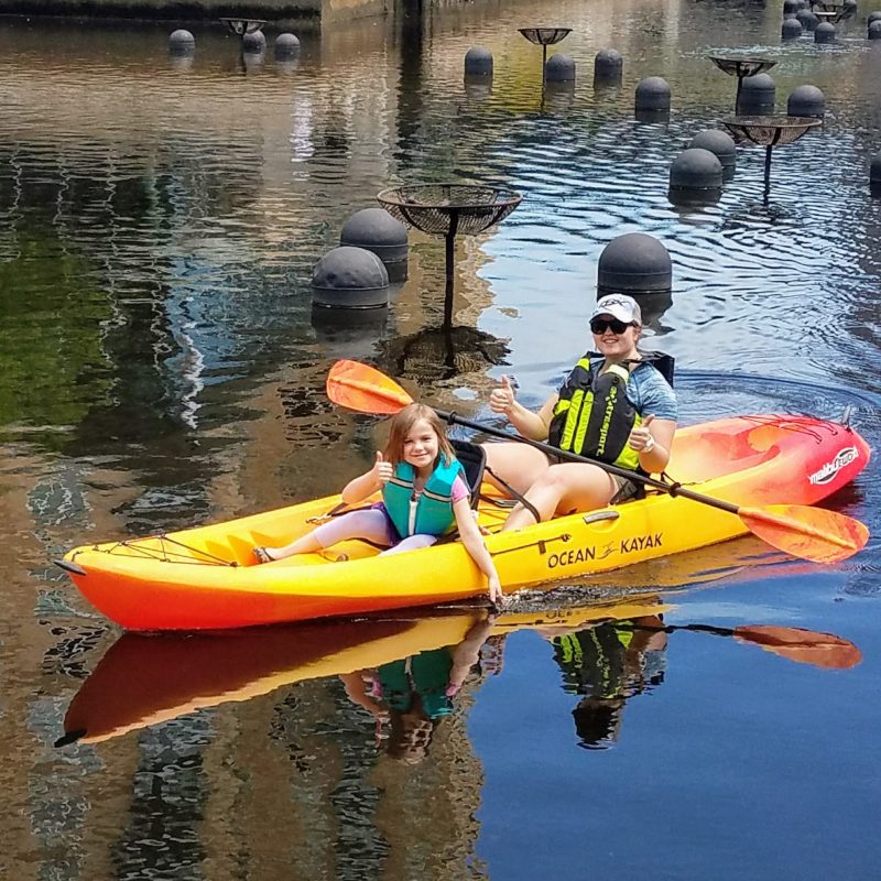 a small yellow boat on a body of water