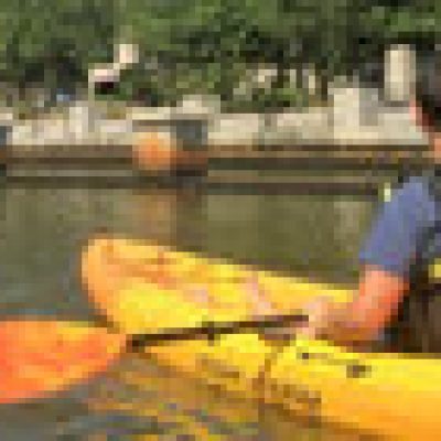 a group of people rowing a boat in a body of water